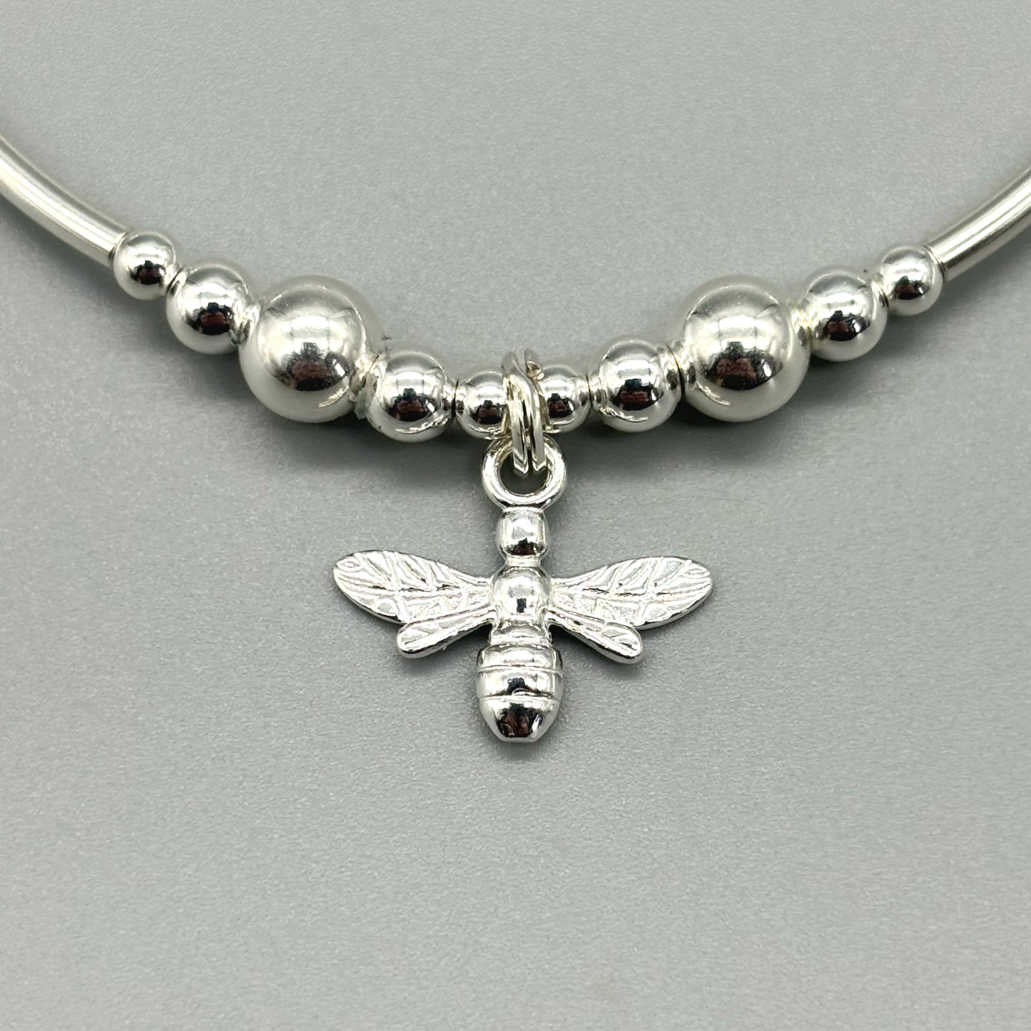 Closeup of bee charm sterling silver stacking bracelet by My Silver Wish