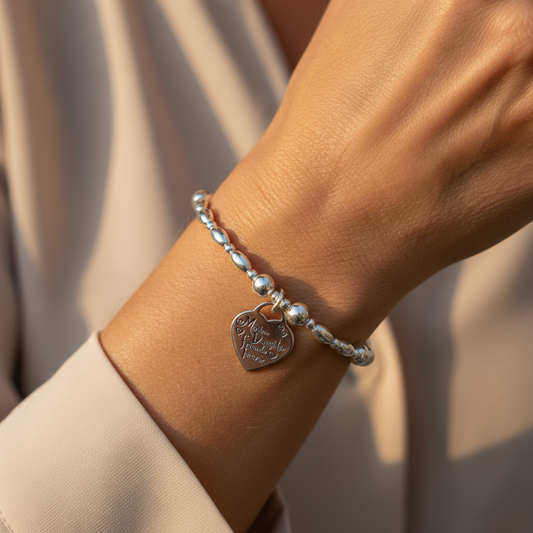 Woman wearing a "Mother & daughter, friends forever" charm sterling silver women's stacking bracelet by My Silver Wish