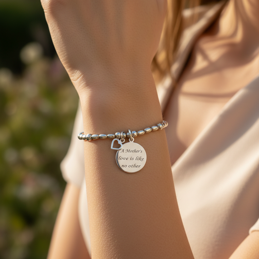 Model wearing a "Mother's Love is Like No Other" sterling silver hand-made women's stacking charm bracelet by My Silver Wish
