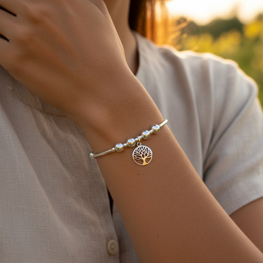 Model wearing a Tree of Life charm sterling silver women's hand-made stacking bracelet by My Silver Wish