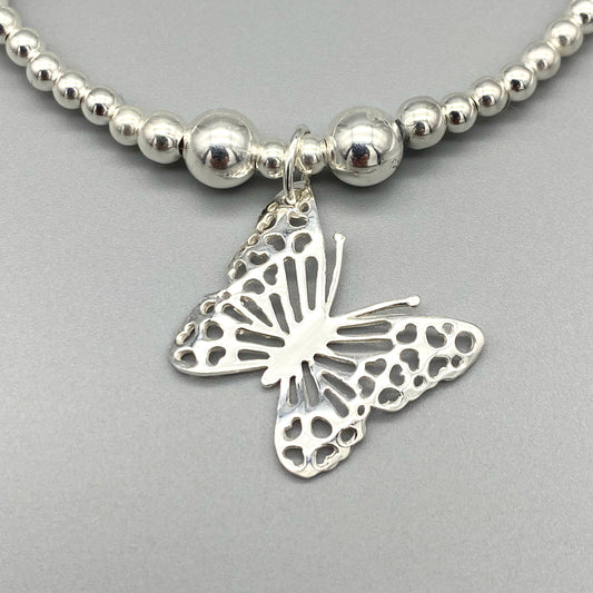 Closeup of Butterfly charm sterling silver stacking bracelet for her by My Silver Wish