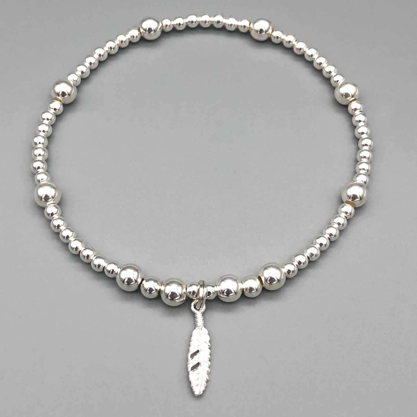 Feather charm sterling silver stacking charm bracelet by My Silver Wish