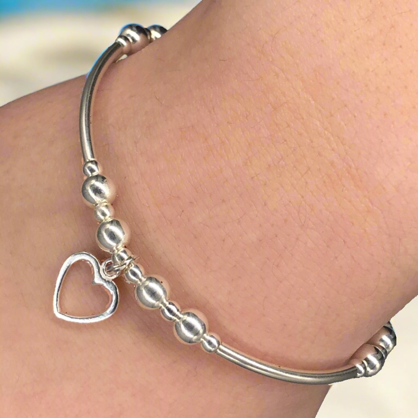 Closeup of Small open heart sterling silver stacking charm bracelet by My Silver Wish