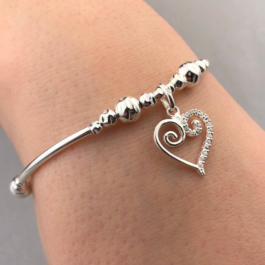 Closeup of Scroll heart charm sterling silver hand-made women's stacking bracelet by My Silver Wish