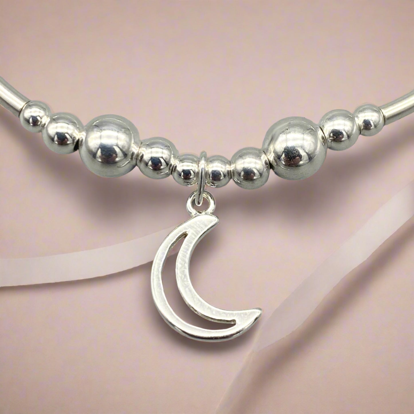 Closeup of Moon charm sterling silver stacking bracelet for her by My Silver Wish