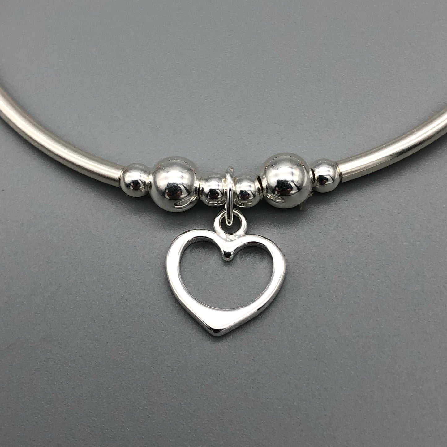 Closeup of Heart Charm Rainbow Crystals Sterling Silver Women's Stacking Bracelet by My Silver Wish