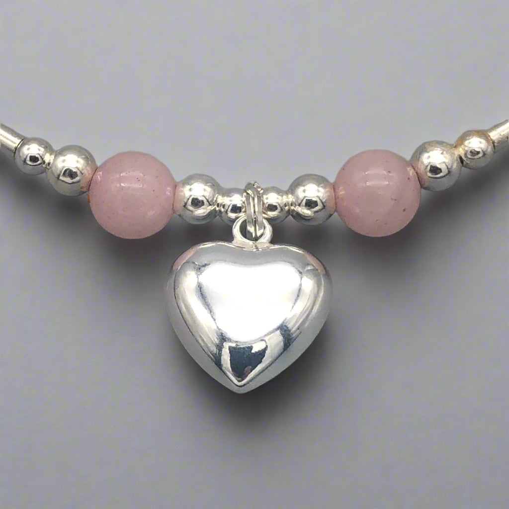 Closeup of Rose quartz solid heart charm sterling silver hand-made stacking bracelet for her by My Silver Wish