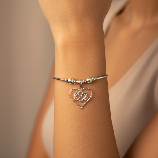 Model wearing an Infinity charm heart women's sterling silver hand-made stacking bracelet by My Silver Wish