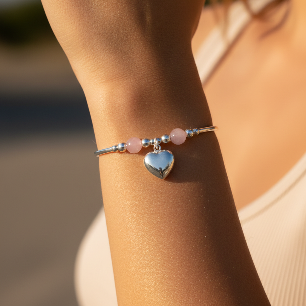Model wearing a Rose quartz solid heart charm sterling silver hand-made stacking bracelet for her by My Silver Wish