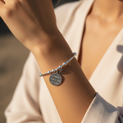 Model wearing a "Mother's Love is Like No Other" & heart charm women's sterling silver stacking bracelet by My Silver Wish