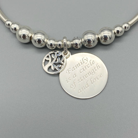 Closeup of "Family is a Circle of Strength & Love" charm sterling silver stacking bracelet for her by My Silver Wish
