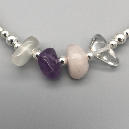 Closeup of Aquarius zodiac star sign women's sterling silver charm stacking bracelet by My Silver Wish